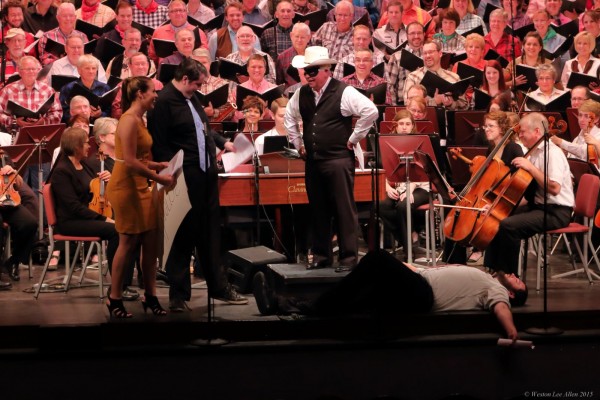 photo of orchestra, conductor dressed as cowboy